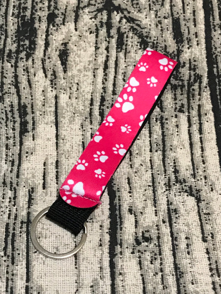 White Paw Prints on Pink Background Wrist Keychain Holder