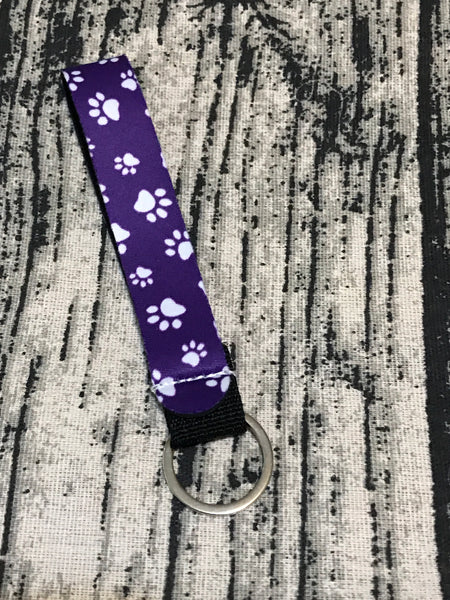 White Paw Prints on Purple Background Wrist Keychain Holder