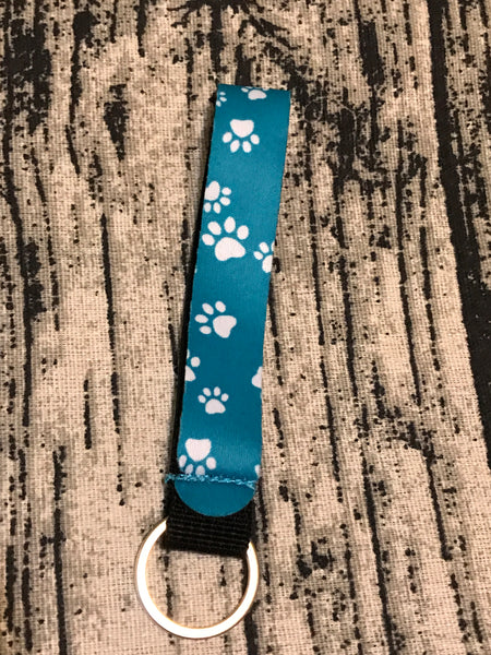 White Paw Prints on Teal Background Wrist Keychain Holder